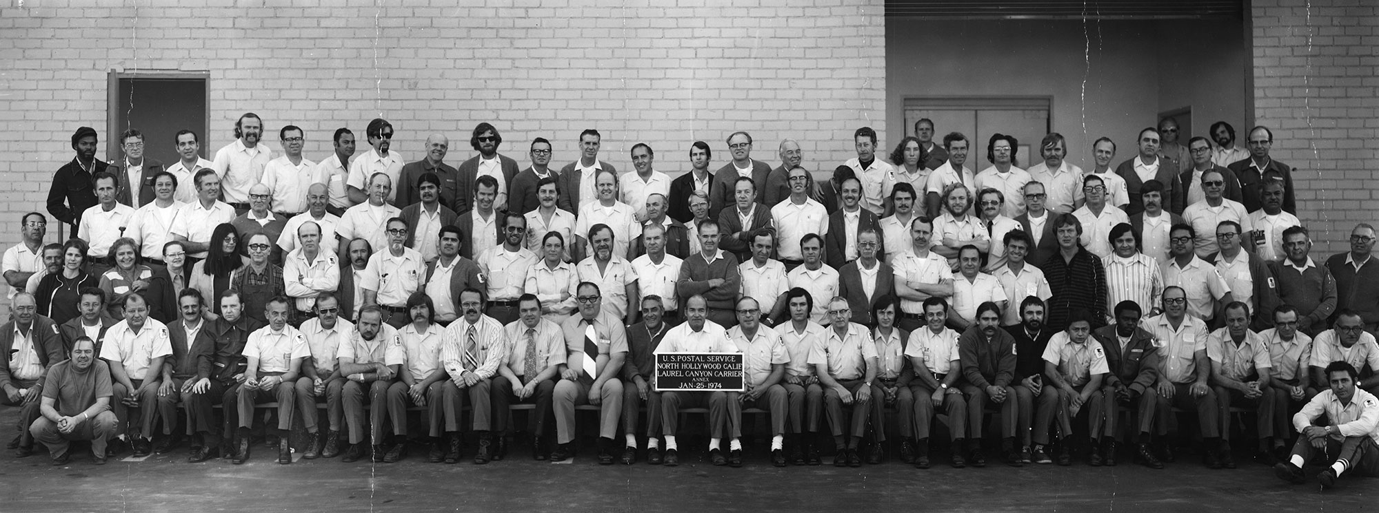 Black and white large group of postal workers posing for a picture