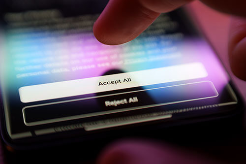 Person reading Cookie Policy on cell phone with large Accept All and Reject All buttons