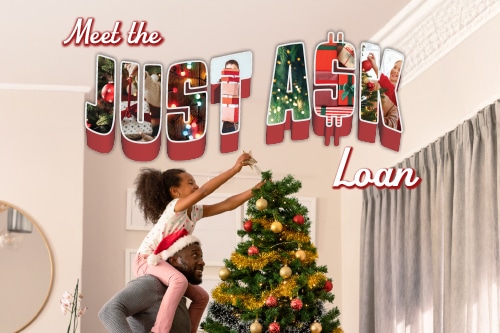 Father lifting daughter to decorate a Christmas tree.