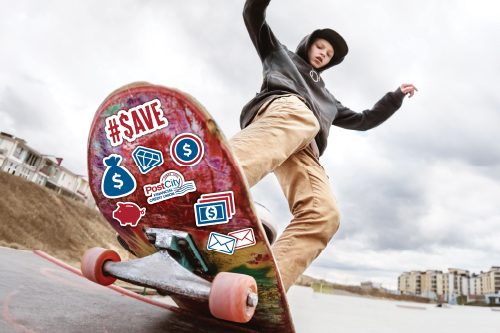 A skateboarder performs a trick on a ramp under a cloudy sky. The skateboard's underside has various money-themed stickers, including dollar signs and a piggy bank.